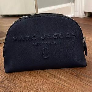 This is a Marc Jacobs cosmetic bag in dark navy. It is in wonderful shape.